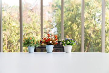 Grop of bouquet colorful artificial flower in vase on modern table