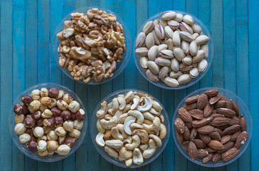 Healthy food. Nuts mix assortment on stone texture top view. Collection of different legumes for background image close up nuts, pistachios, almond, cashew nuts, peanut, walnut. image