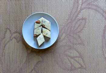 Oriental dessert halva with pistachio, almond, cashew nuts, peanut, walnut  on a  plate. Image....