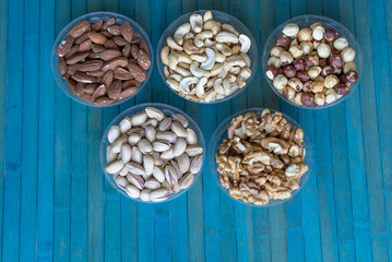 Healthy food. Nuts mix assortment on stone texture top view. Collection of different legumes for background image close up nuts, pistachios, almond, cashew nuts, peanut, walnut. image