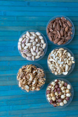Healthy food. Nuts mix assortment on stone texture top view. Collection of different legumes for background image close up nuts, pistachios, almond, cashew nuts, peanut, walnut. image
