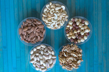 Healthy food. Nuts mix assortment on stone texture top view. Collection of different legumes for background image close up nuts, pistachios, almond, cashew nuts, peanut, walnut. image