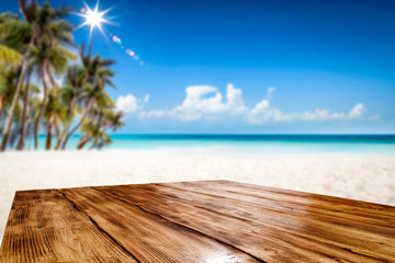 Fototapeta premium Summer table background of free space for your decoration and landscape of beach with palms. 