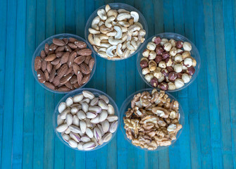Healthy food. Nuts mix assortment on stone texture top view. Collection of different legumes for background image close up nuts, pistachios, almond, cashew nuts, peanut, walnut. image