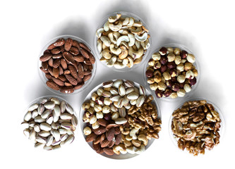Healthy food. Nuts mix assortment on white grey table top view. Collection of different legumes for background image close up nuts, pistachios, almond, cashew nuts, peanut, walnut. image