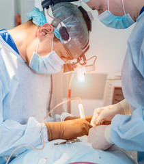 Spinal surgery. Group of surgeons in operating room with surgery equipment. Laminectomy