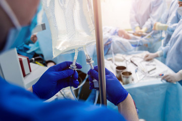 Arthroscope surgery. Orthopedic surgeons in teamwork in the operating room with modern arthroscopic...