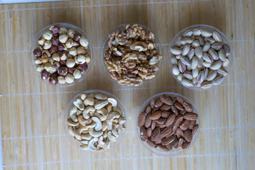 Healthy food. Nuts mix assortment on stone texture top view. Collection of different legumes for background image close up nuts, pistachios, almond, cashew nuts, peanut, walnut. image