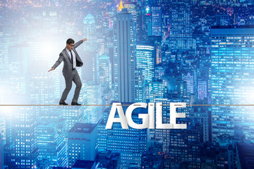 Agile transformation concept with businessman walking on tight r