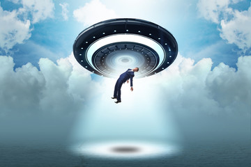 Flying saucer abducting young businessman 