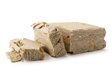 Halva sunflower cut into pieces on a white, close-up. Isolated.