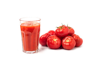 Tomato juice in a glass, with tomatoes on a white background