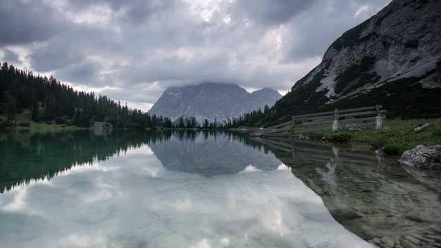 Time lapse reflection of clouds and mountain Zugspitze in lake Seebensee Bavaria Germany Alps Ehrwald Tirol. Timelapse travel hiking wanderlust landscape