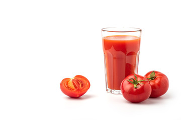 Tomato juice in a glass, with tomatoes on a white background
