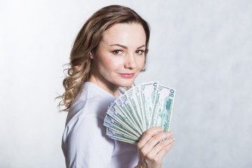 Happy young smiling woman hold us dollar money in hand over white background.