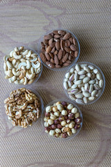Healthy food. Nuts mix assortment on stone texture top view. Collection of different legumes for background image close up nuts, pistachios, almond, cashew nuts, peanut, walnut. image