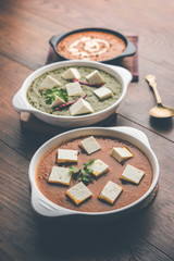 Palak paneer butter masala, yellow dal or dal-makhani served in a bowl in a group. selective focus