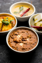 Palak paneer butter masala, yellow dal or dal-makhani served in a bowl in a group. selective focus