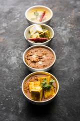 Palak paneer butter masala, yellow dal or dal-makhani served in a bowl in a group. selective focus