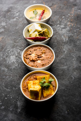 Palak paneer butter masala, yellow dal or dal-makhani served in a bowl in a group. selective focus