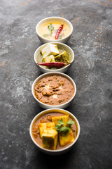 Palak paneer butter masala, yellow dal or dal-makhani served in a bowl in a group. selective focus