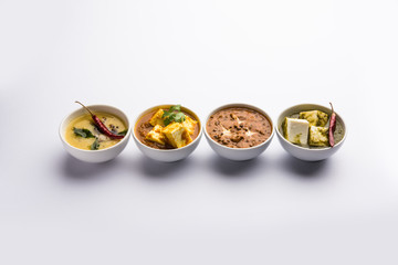 Palak paneer butter masala, yellow dal or dal-makhani served in a bowl in a group. selective focus