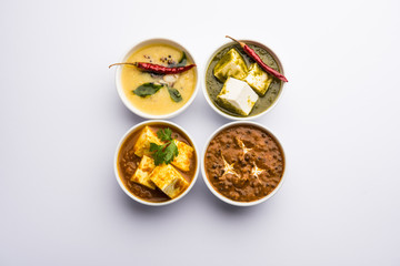 Palak paneer butter masala, yellow dal or dal-makhani served in a bowl in a group. selective focus