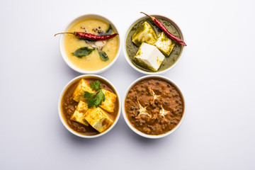 Palak paneer butter masala, yellow dal or dal-makhani served in a bowl in a group. selective focus
