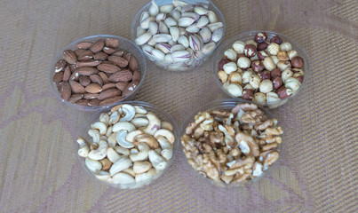 Healthy food. Nuts mix assortment on stone texture top view. Collection of different legumes for background image close up nuts, pistachios, almond, cashew nuts, peanut, walnut. image