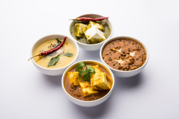 Palak paneer butter masala, yellow dal or dal-makhani served in a bowl in a group. selective focus