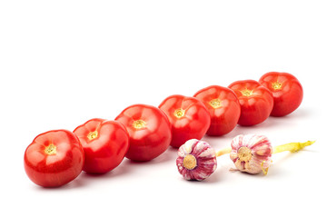 Still life, juicy, red, ripe tomatoes,with garlic,on a white background