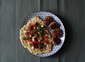 Photo plates with food top view Afghan flatbread with capers, meatballs and Salsa sauce