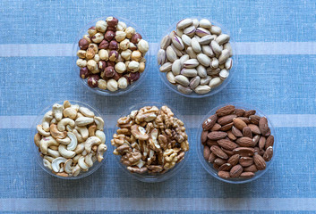 Healthy food. Nuts mix assortment on stone texture top view. Collection of different legumes for background image close up nuts, pistachios, almond, cashew nuts, peanut, walnut. image