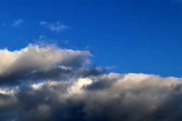 Dark forming clouds with blue sky elements right before a thunderstorm