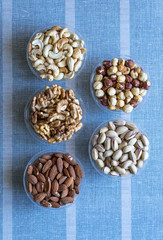 Healthy food. Nuts mix assortment on stone texture top view. Collection of different legumes for background image close up nuts, pistachios, almond, cashew nuts, peanut, walnut. image