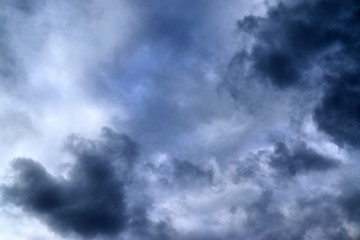 Dark forming clouds with blue sky elements right before a thunderstorm