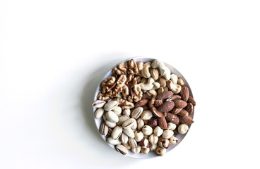 Healthy food. Nuts mix assortment on white grey table top view. Collection of different legumes for background image close up nuts, pistachios, almond, cashew nuts, peanut, walnut. image