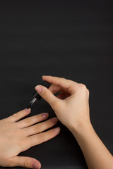 The hands of a young girl make a manicure with shellac coating and nail strengthening