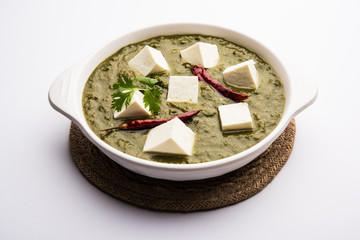 Palak Paneer Curry made up of spinach and cottage cheese served in a bowl. selective focus