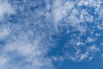 Blue sky with patchy white clouds.