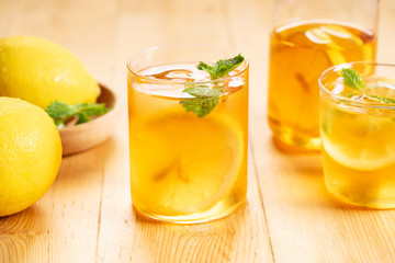 Fototapeta premium iced tea with lemon slices and fresh mint leaves