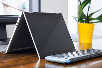 convertible laptop on office desk