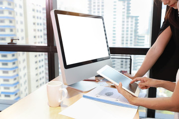 portrait of asian senior businesswoman teaching new generation businesswoman by teaching how to work on tablet with attention face