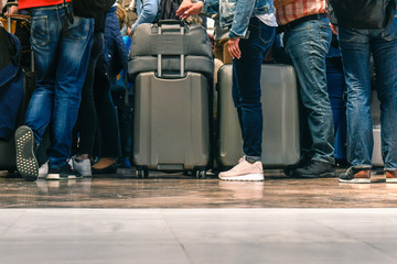 Passengers waiting in line for boarding an airport for a flight, travelers queue at check-in,...
