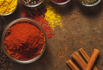 Red Ground Paprika. Place for text. Different types of Spices in a bowl on a stone background. The view from the top