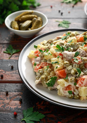 Russian traditional salad Olivier with vegetables and meat.