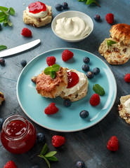 Classic English scones with clotted cream, strawberries jam and other fruit