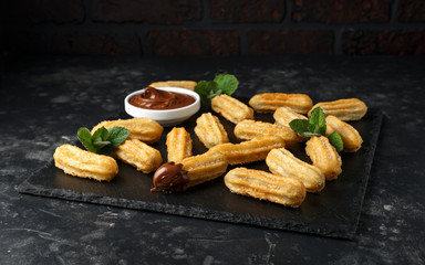 Churros with chocolate dipping sauce. sugar and cinnamon.