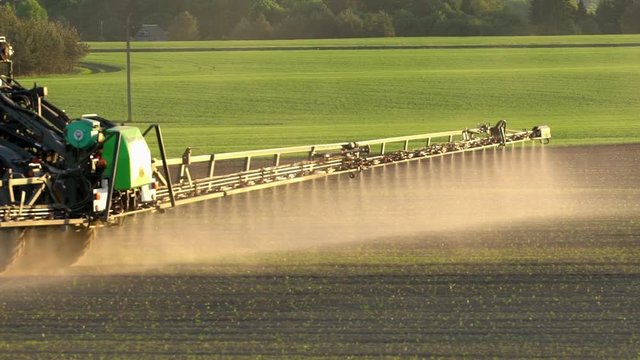 Agriculture field spray with herbicide. Handheld slow motion 100fps follow shot