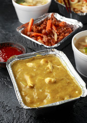 Chinese takeaway food. Pork Wonton dumpling soup, Crispy shredded beef, sweet and sour pineapple chicken, egg noodles with bean sprouts, curry.